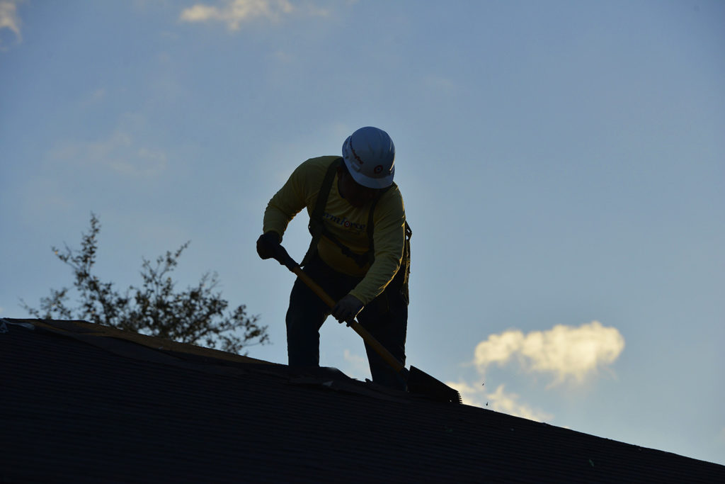 Stormforce Contractor working on top of residential roof.