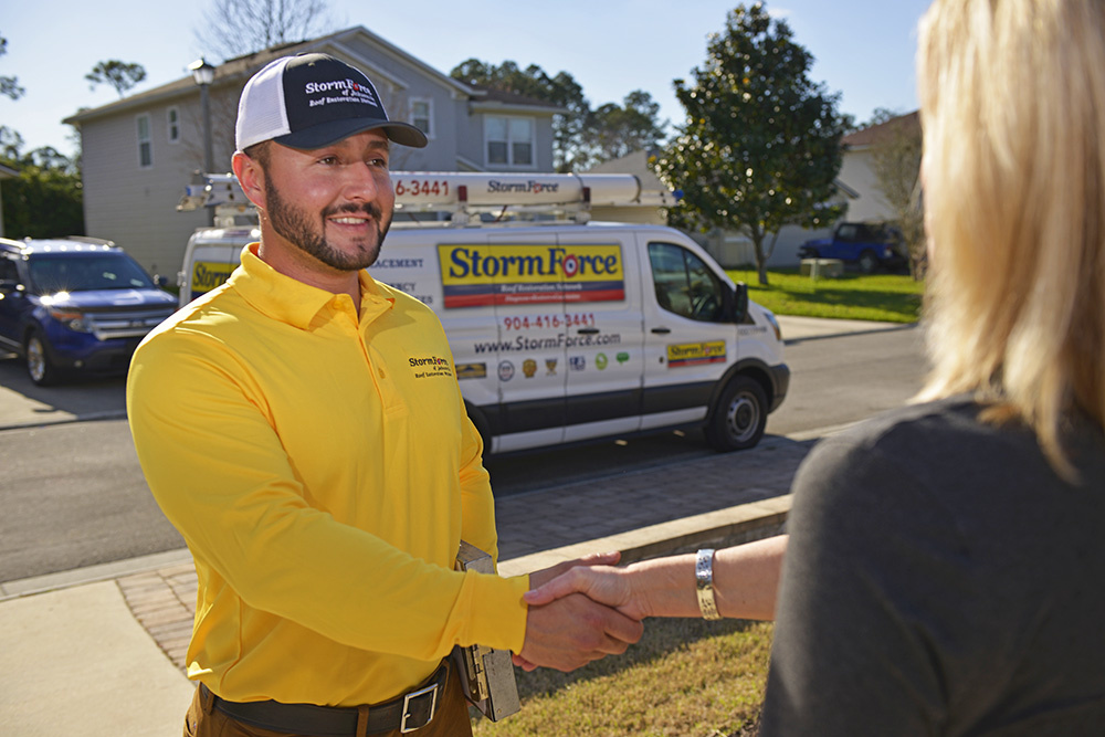 Stormforce Roofing Contractor of Ponte Vedra, FL shaking hands with a homeowner.