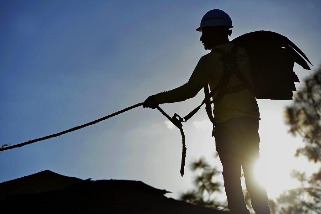 A StormForce crew member working on the roof of a commercial roof in Palm Coast, Florida.