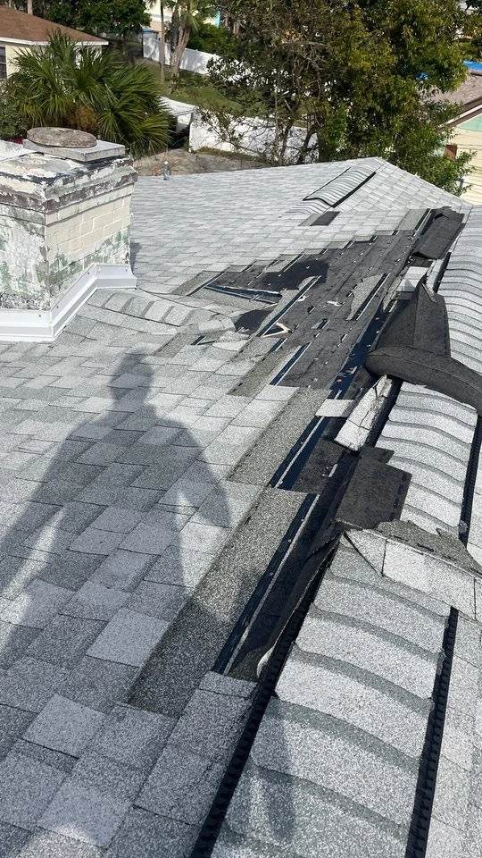 A damaged roof being inspected by a StormForce crew member after Hurricane Ian.