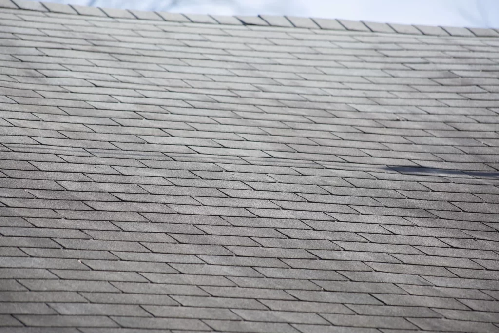 A hail damaged roof with loose shingles.