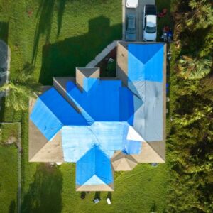 Blue tarps on a home after storm damage